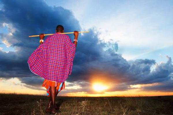 Maasai Elder watching the sunset over the Maasai Mara - Serengeti Plains